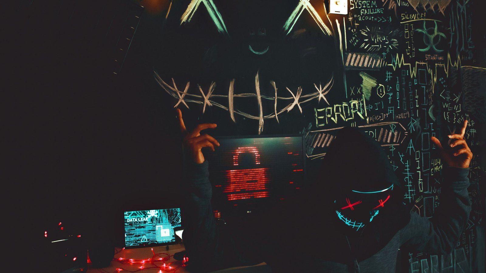A masked figure behind a screen showing a locked padlock and a data-leak warning
